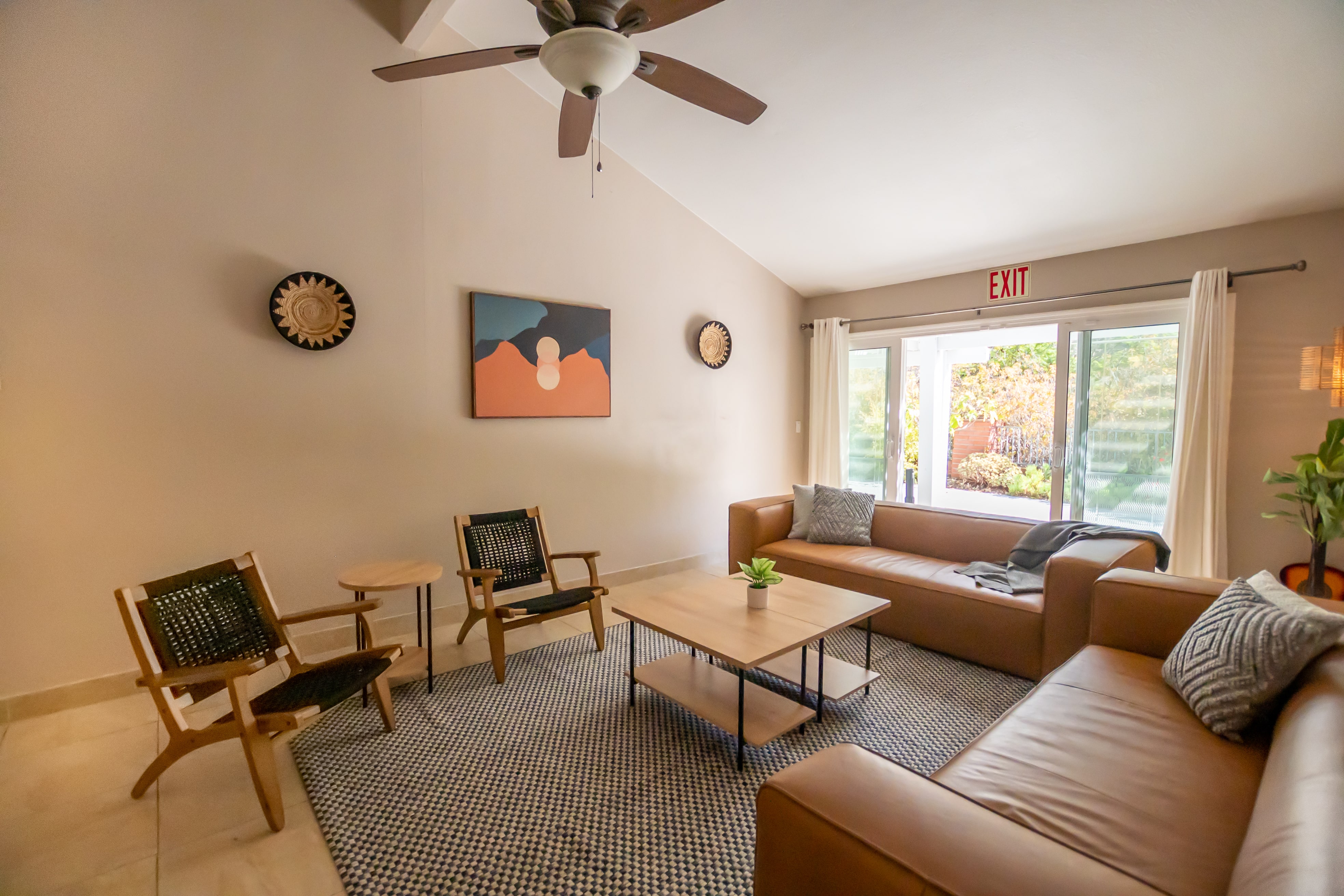 Lounge with couches, wood chairs, and patterned rug
