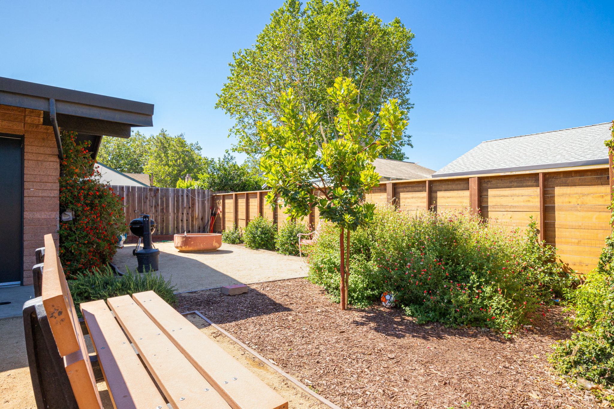 Outdoor courtyard with benches and landscaped walking paths