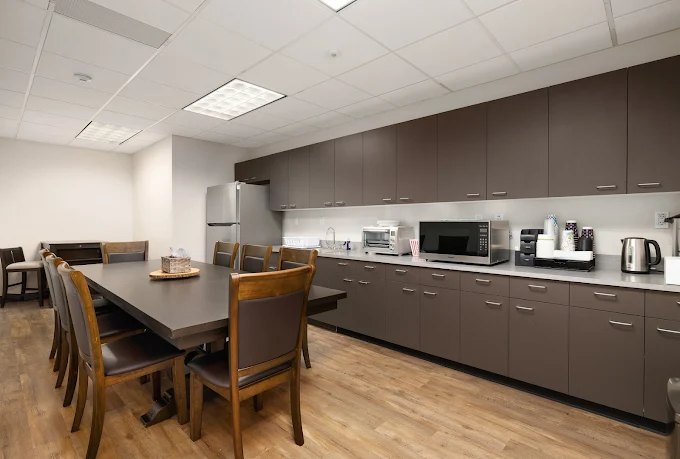Kitchen with dining table, cabinets, and stainless appliances