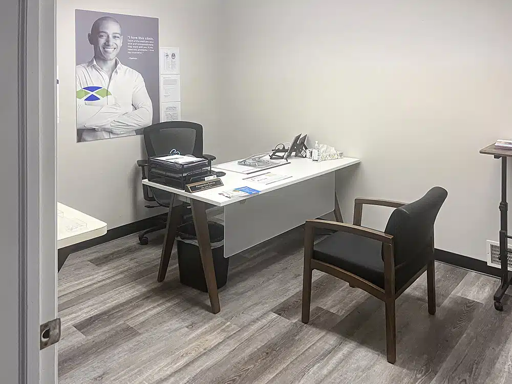 Office with desk, chair, and motivational poster on wall