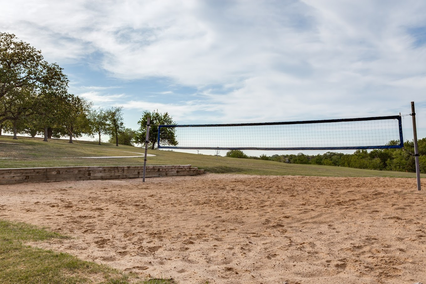 Outdoor sand volleyball court with a scenic landscape view