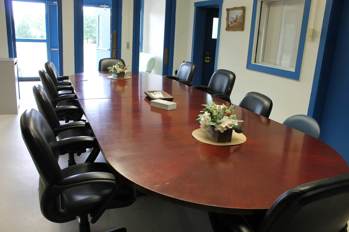 Long table with chairs in bright meeting room
