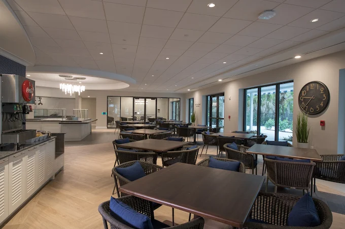 Contemporary cafeteria with dark tables and large windows