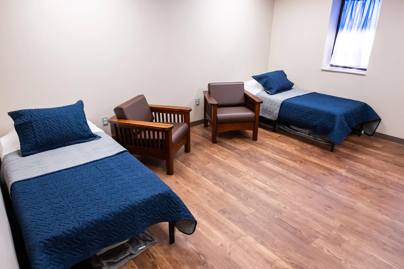Shared bedroom with two beds and seating