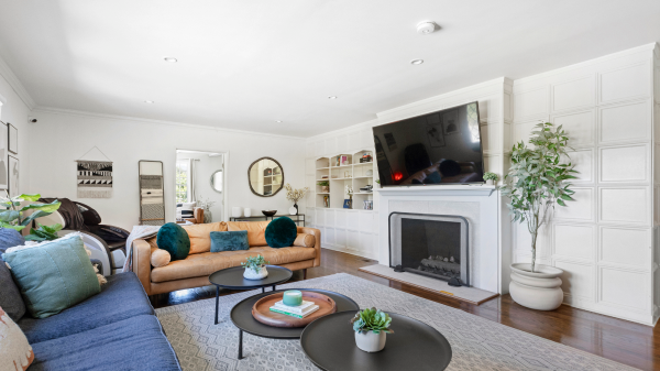 Cozy lounge with sofas, fireplace, and large flat-screen TV