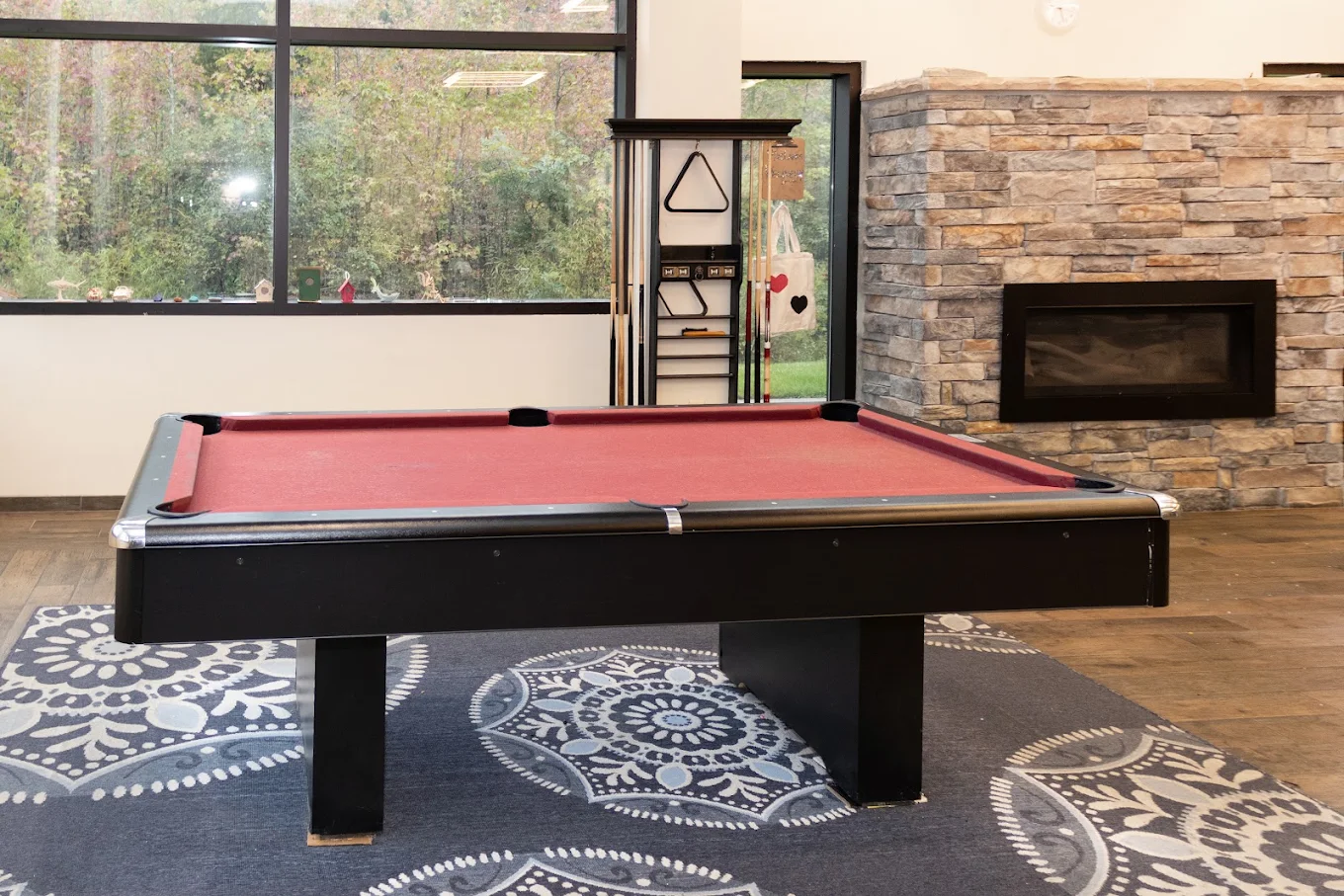 Billiards room with pool table, fireplace, and large windows