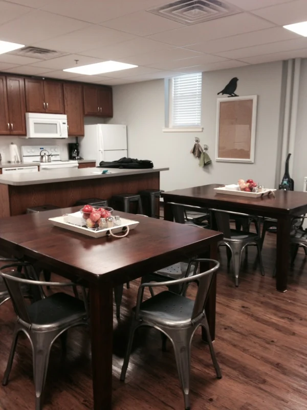 Kitchen with wooden tables and metal chairs in dining area