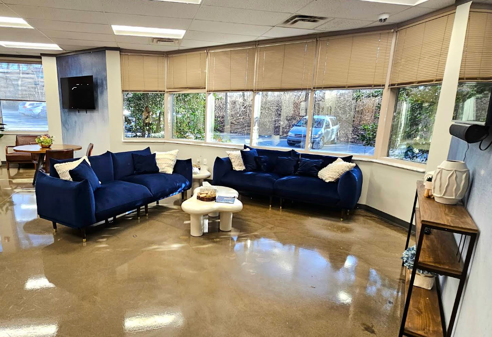 Cozy lounge with blue sofas and large windows