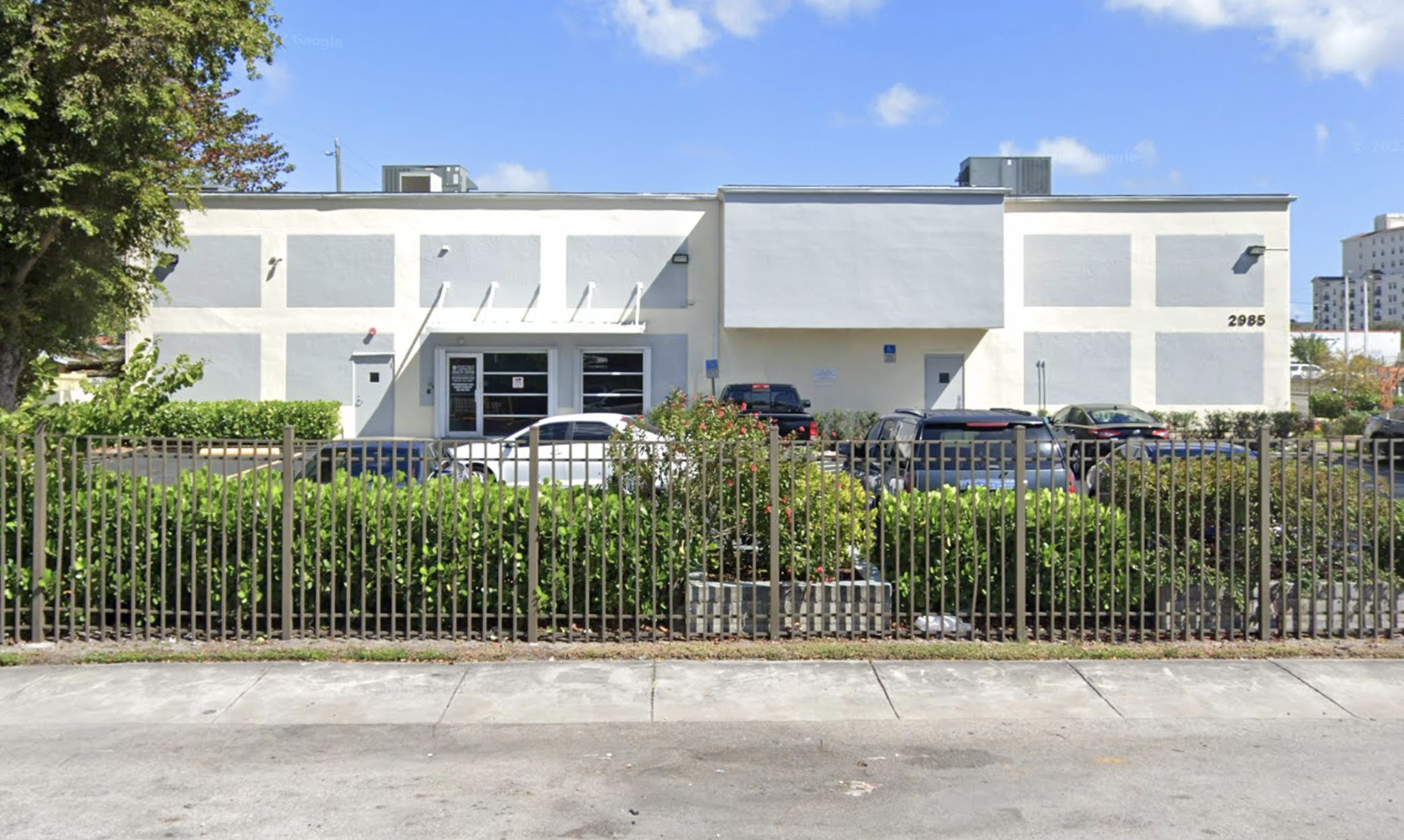 Two-story rehab facility with fenced parking area