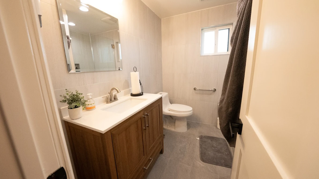 Bathroom with vanity, mirror, and walk-in shower
