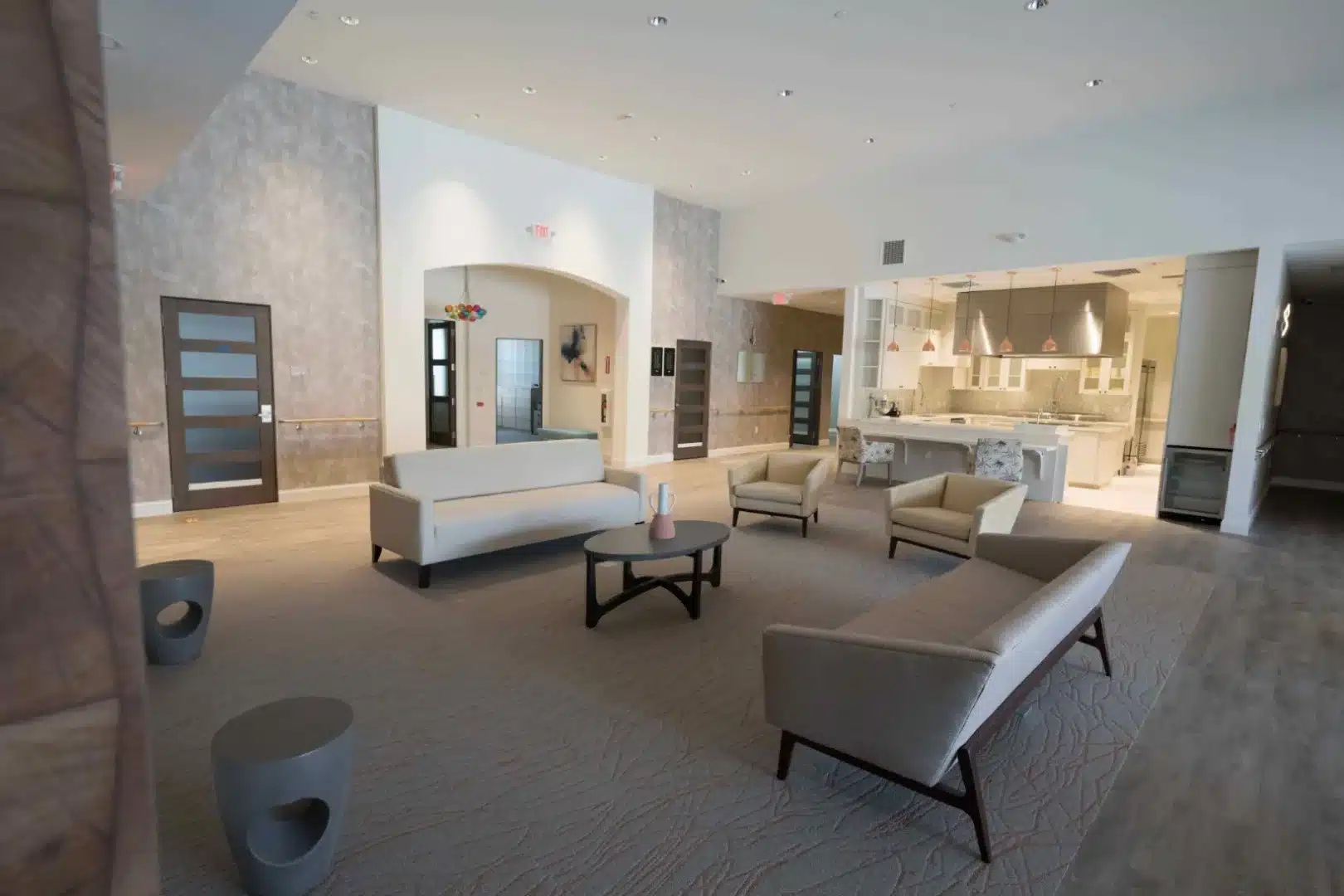 Bright common space with chairs, tables, and a welcoming ambiance.