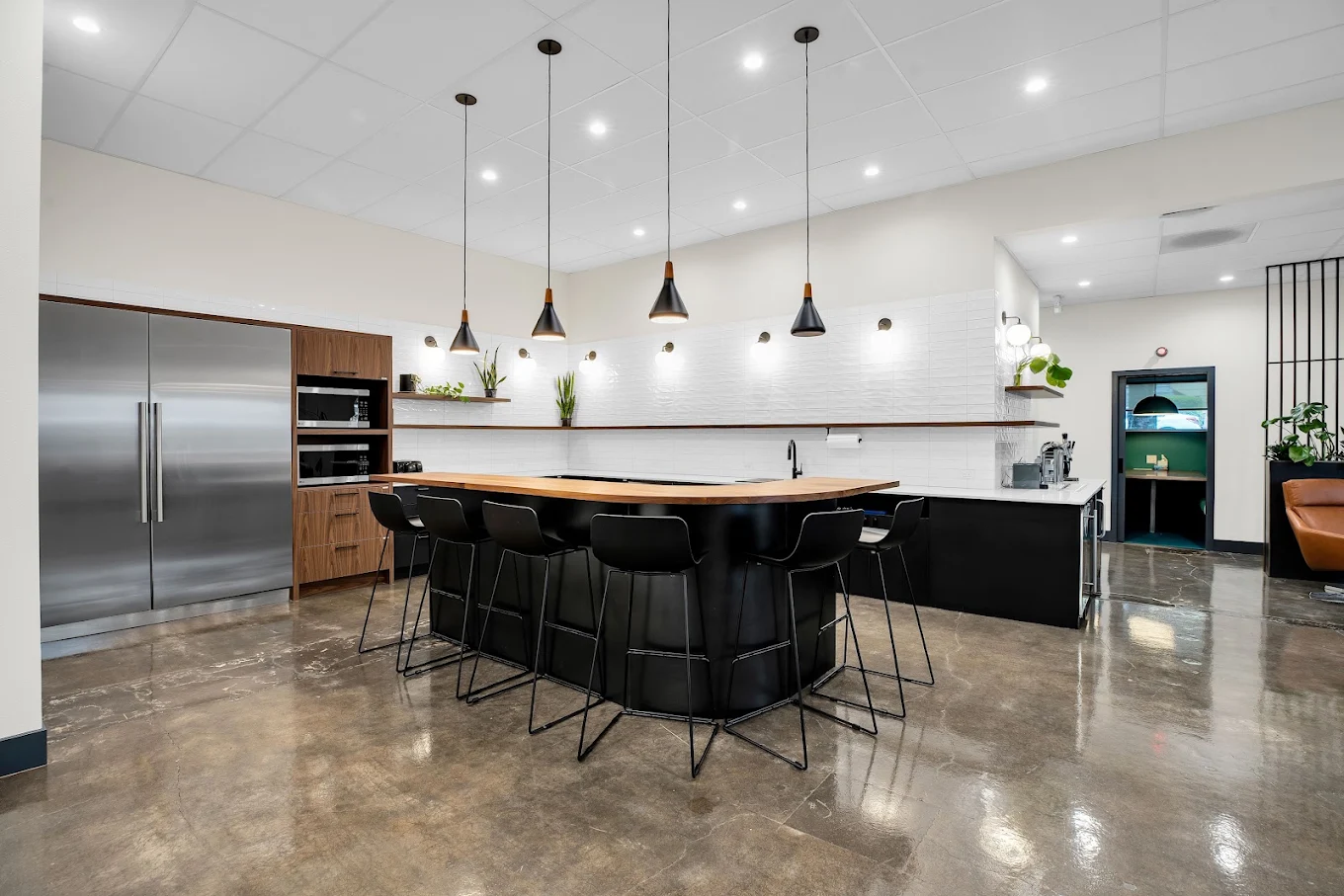 Modern communal kitchen with island and bar seating