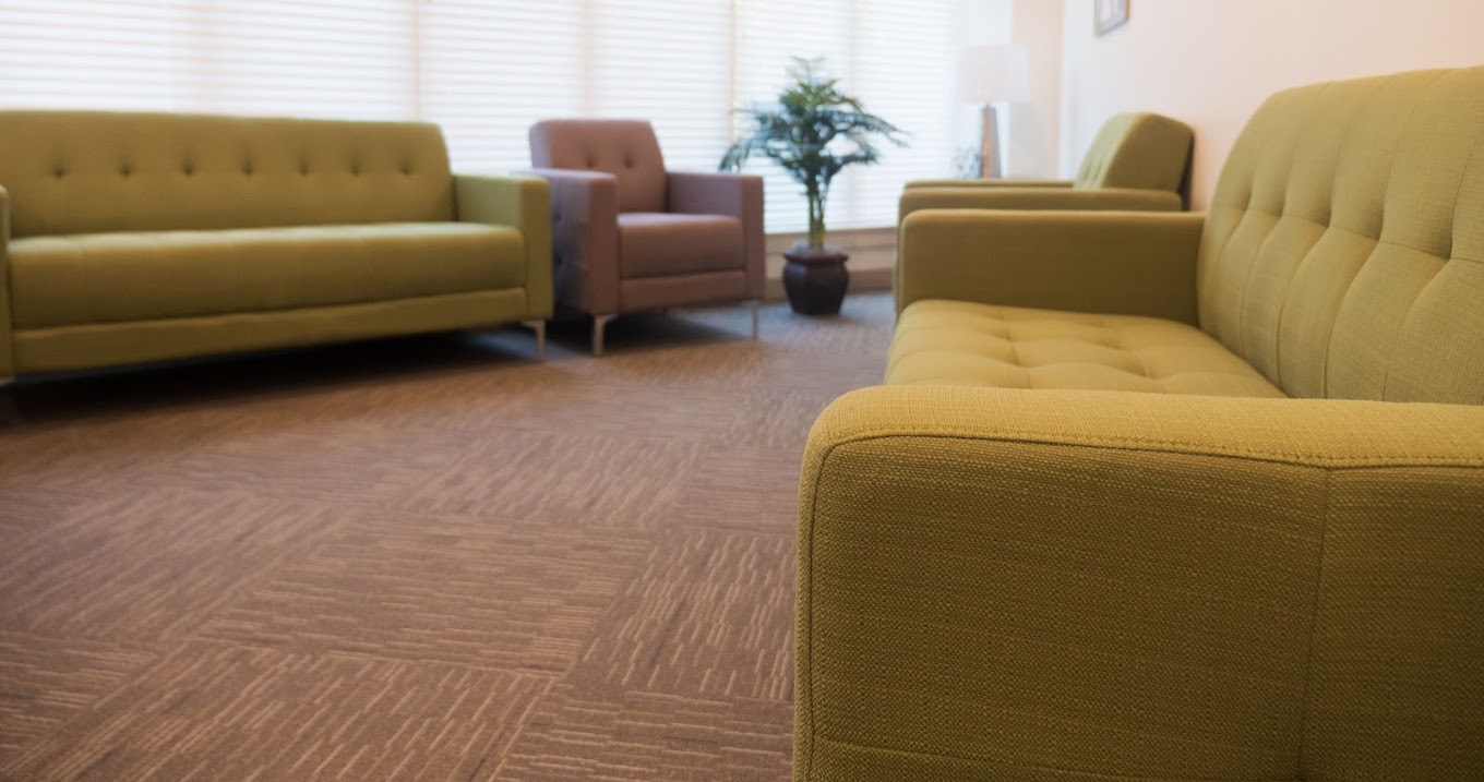 Bright room with green and mauve couches