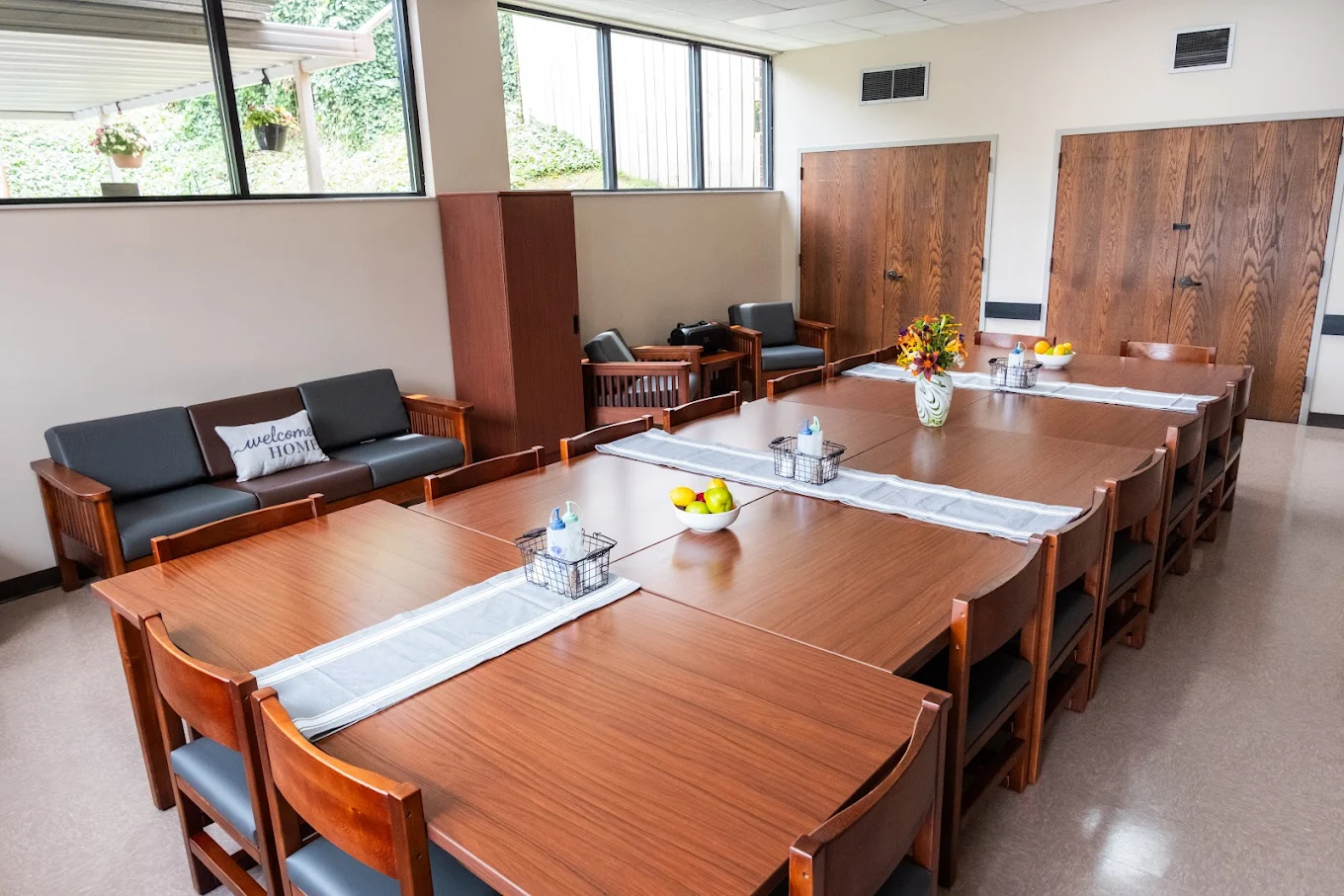 Community dining room with long tables and seating