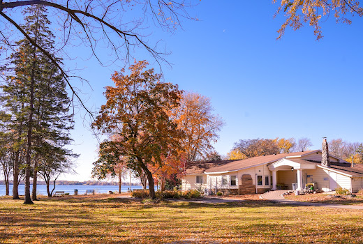 Residential treatment building surrounded by trees near lake