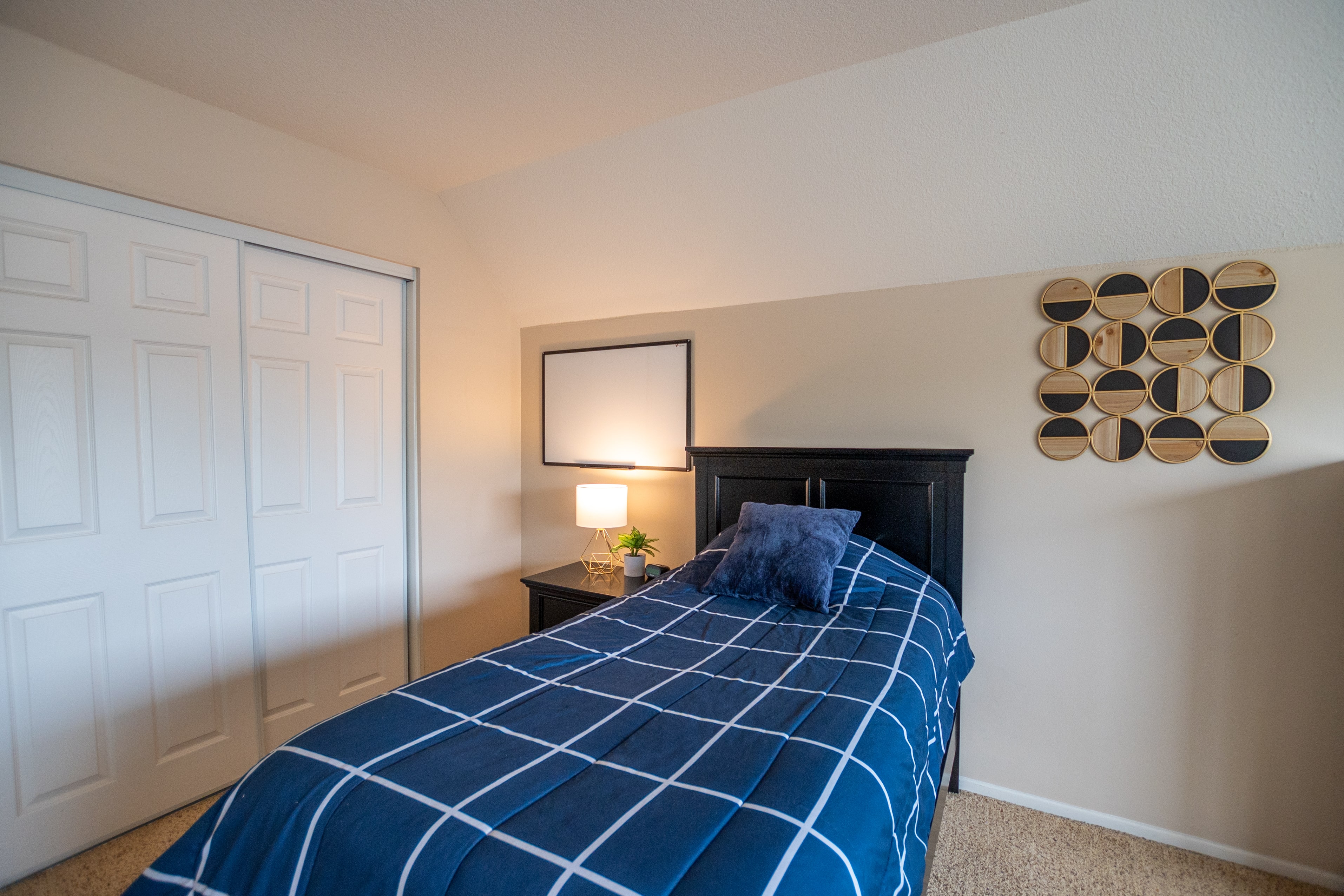 Single twin bed with geometric wall art