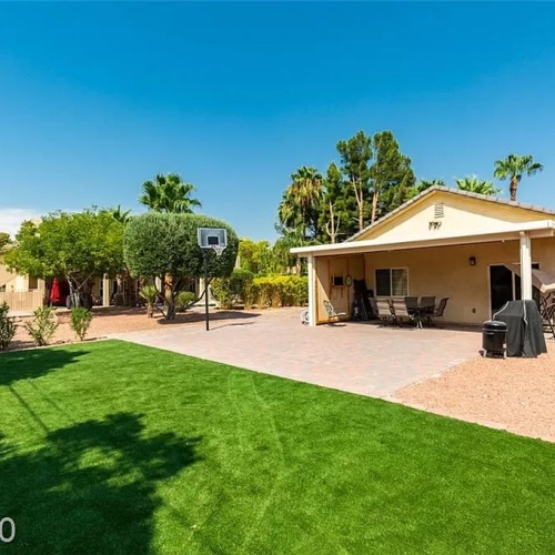 Paved outdoor recreation area with basketball hoop