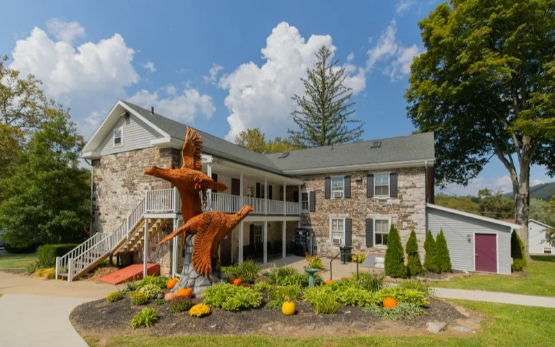 Stone rehab center building with eagle sculpture entrance