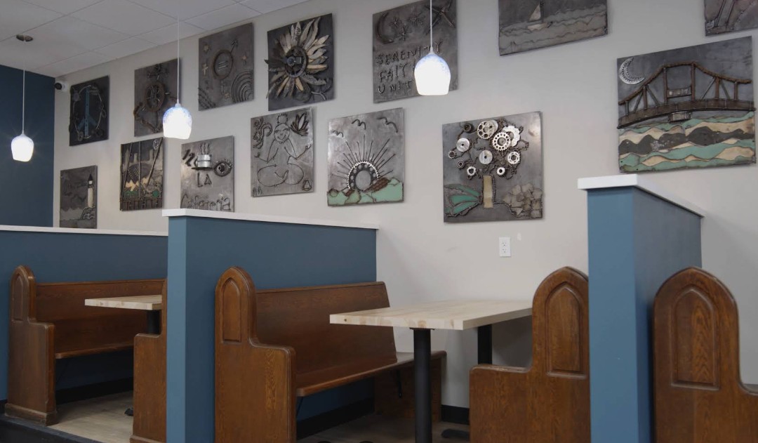 Coffee shop seating with booths and local artwork