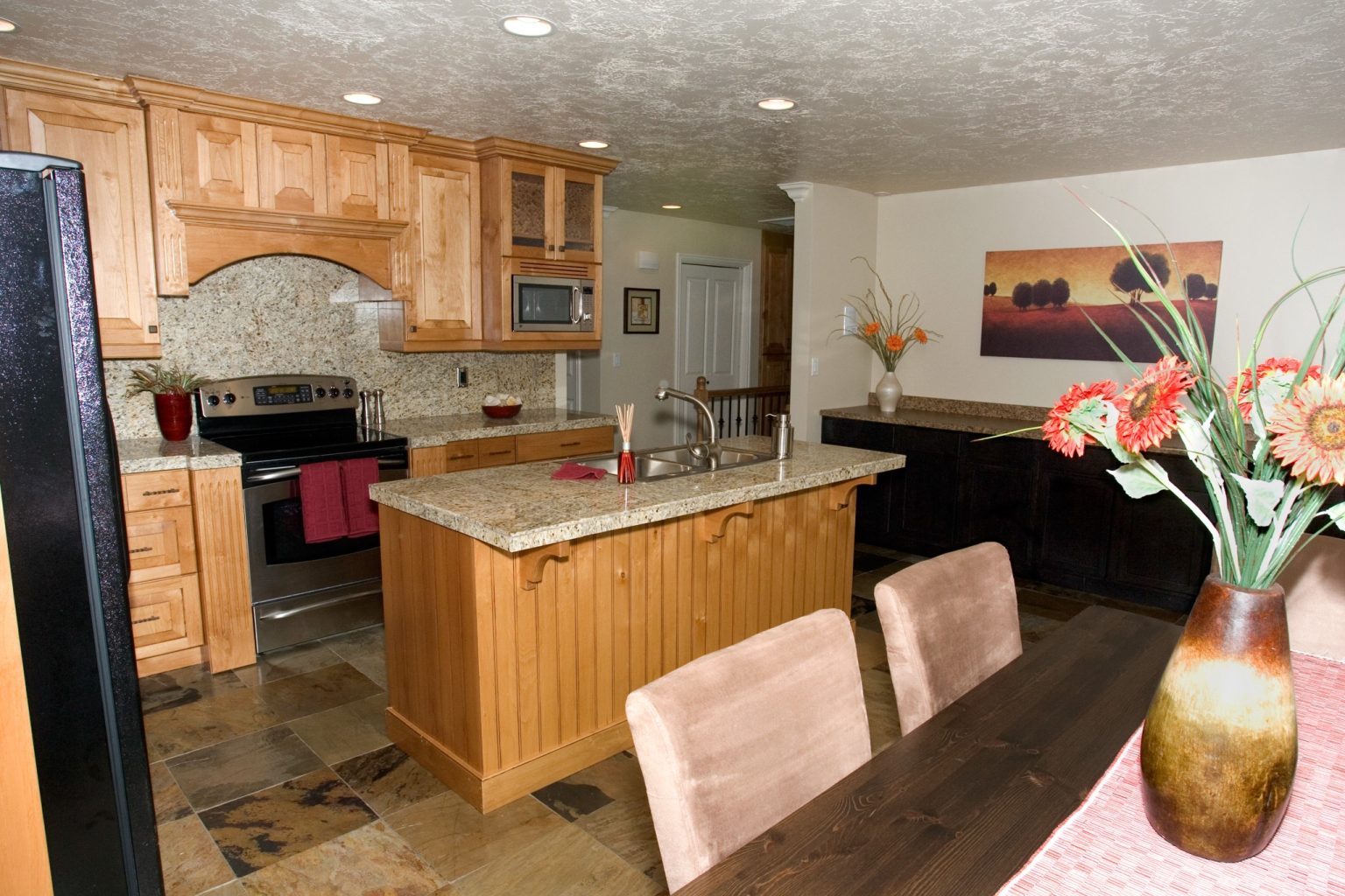 Full kitchen with island, granite counters, and appliances