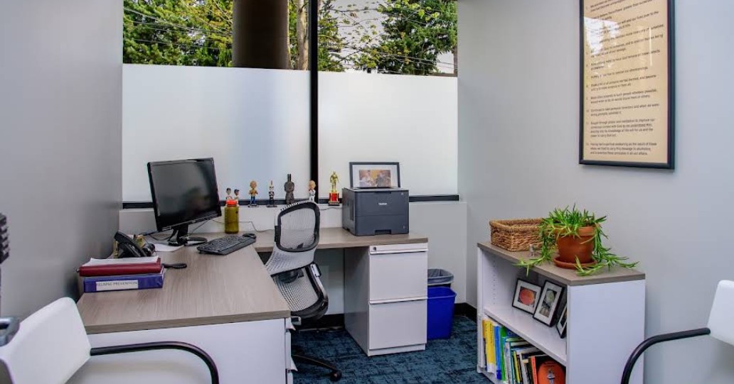 Private therapy office with desk and seating