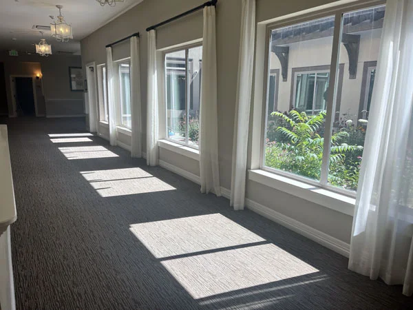 Bright hallway with large windows overlooking a courtyard