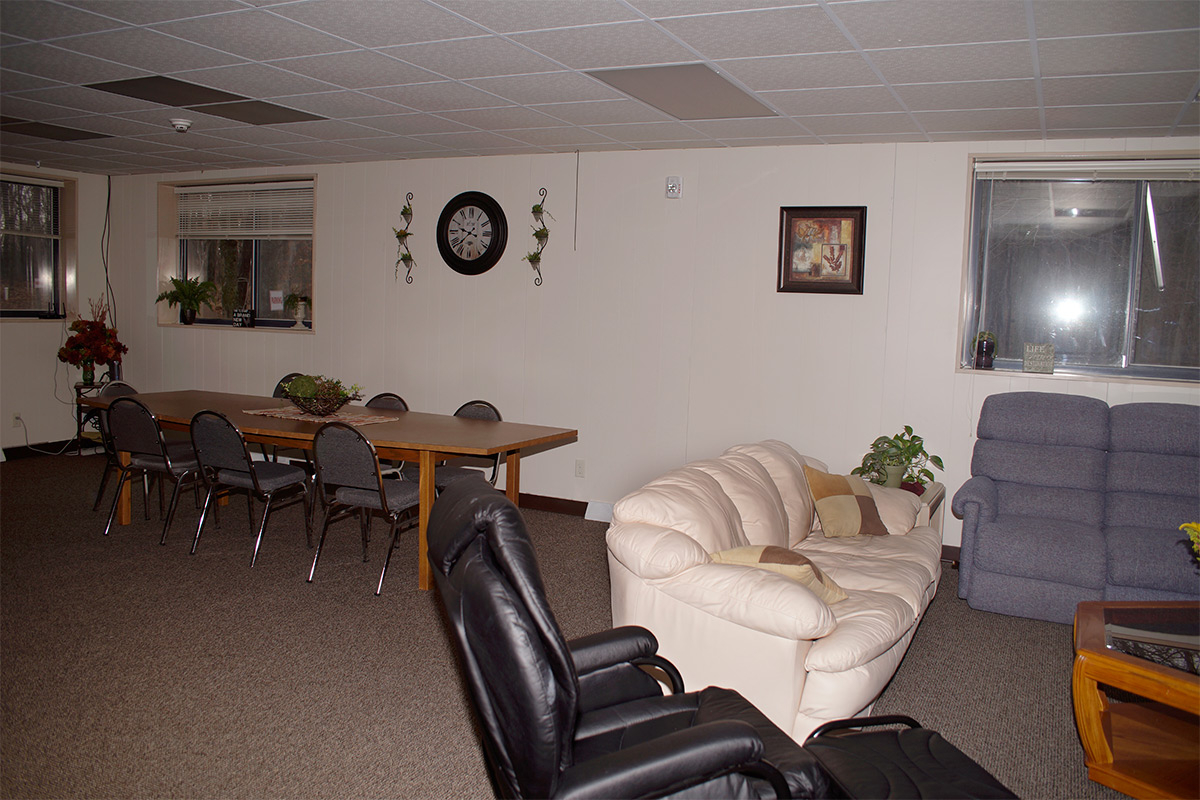 Open dining and living area with tables, couches, and seating