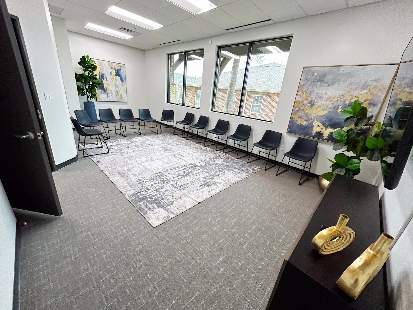 Circle of blue chairs in therapy room