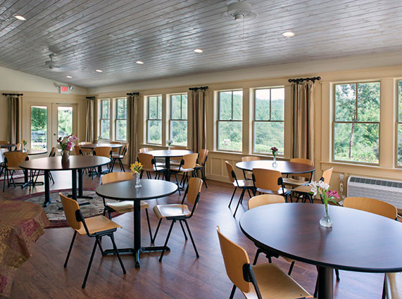 Bright dining room with round tables and large windows