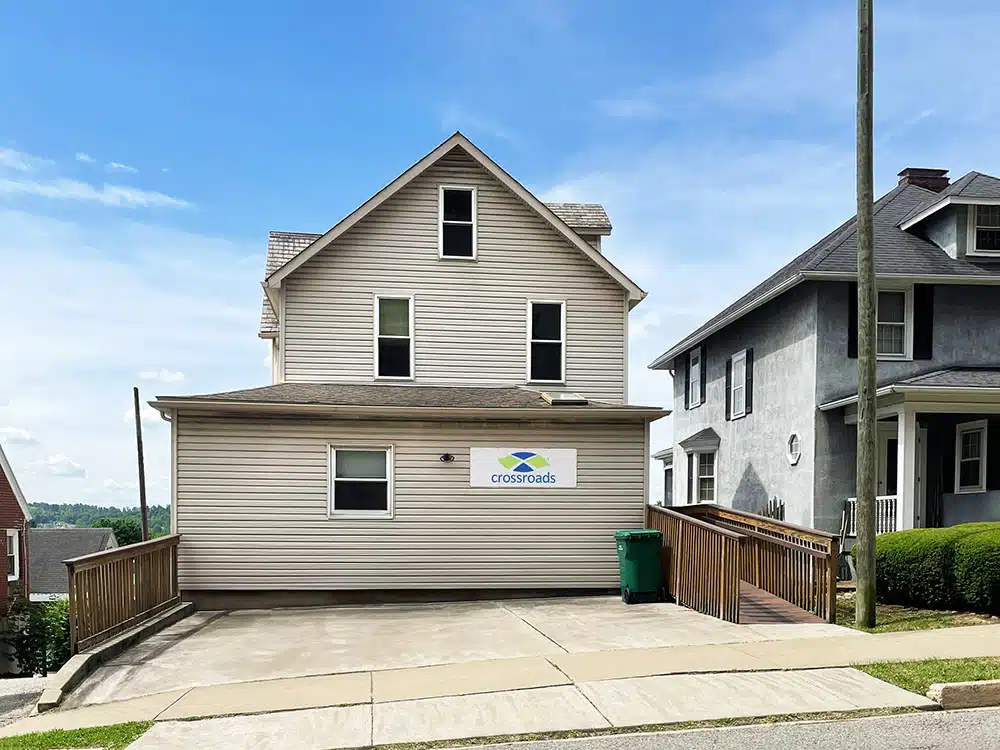 Small beige clinic building with ramp and driveway