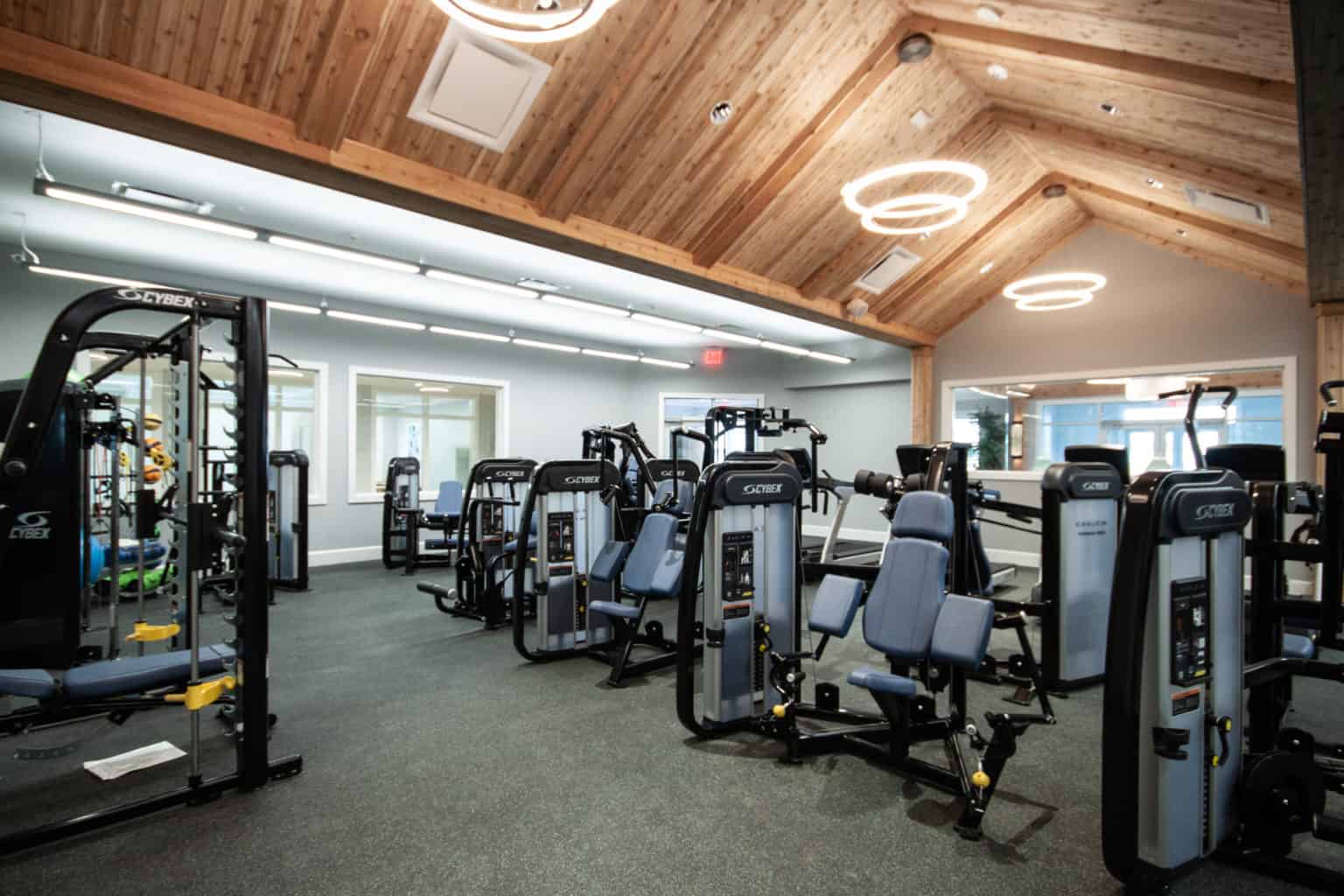 Gym with Cybex workout machines under wood beam ceiling