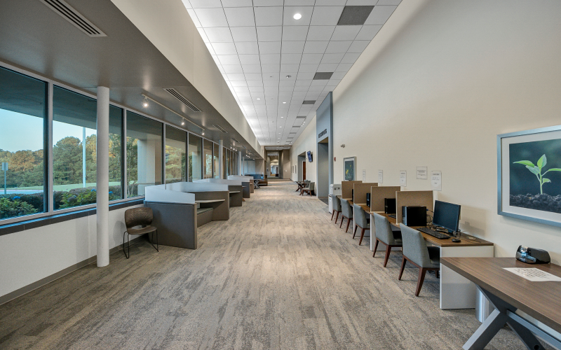 Hallway with computer workstations and seating areas