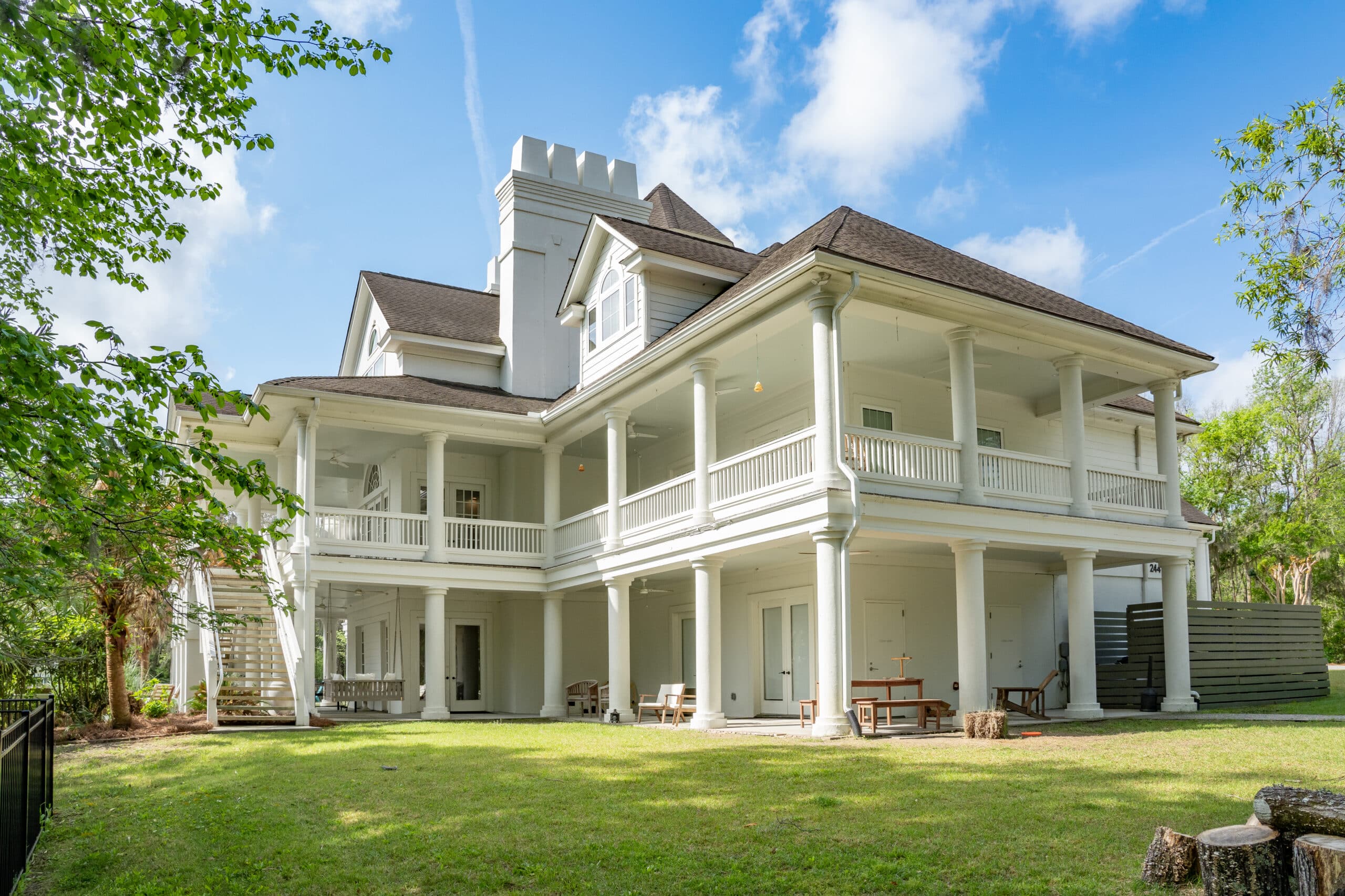 Rear exterior with wraparound porches and lawn