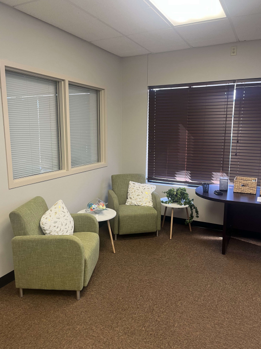 Private consultation room with chairs and desk