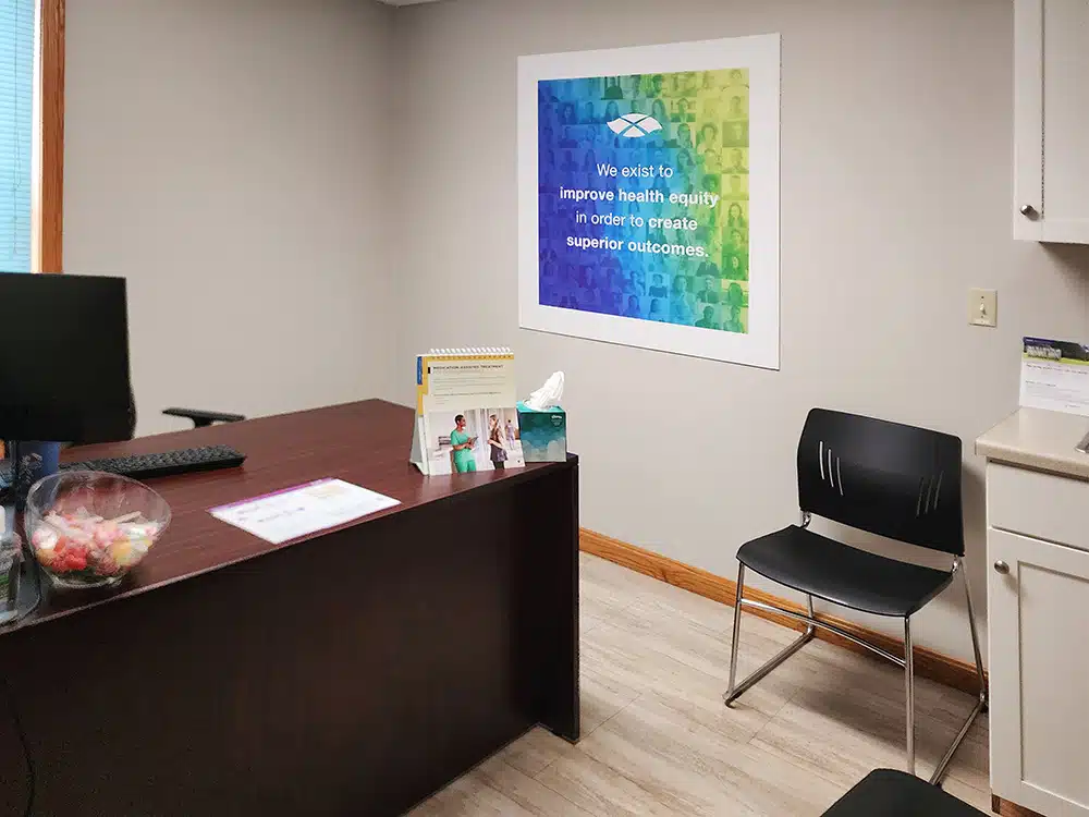 Clinic desk with chair and informational materials