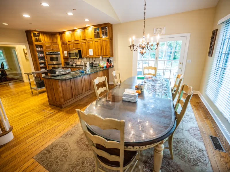 Dining room with large table beside an open kitchen