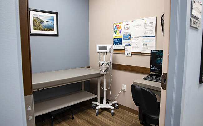 Clinical exam room with exam table and medical equipment