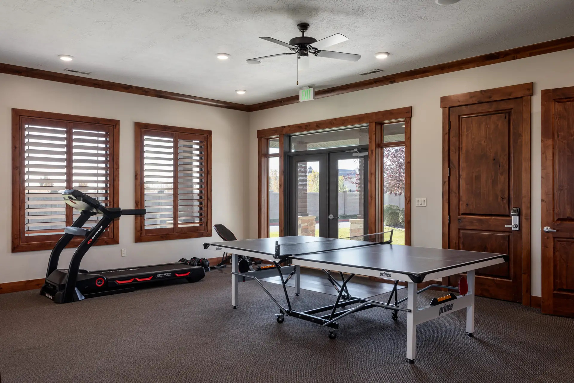 Room with ping pong table and treadmill