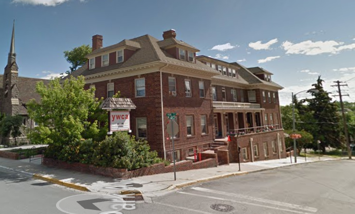Red-brick YWCA building on a street corner with front steps