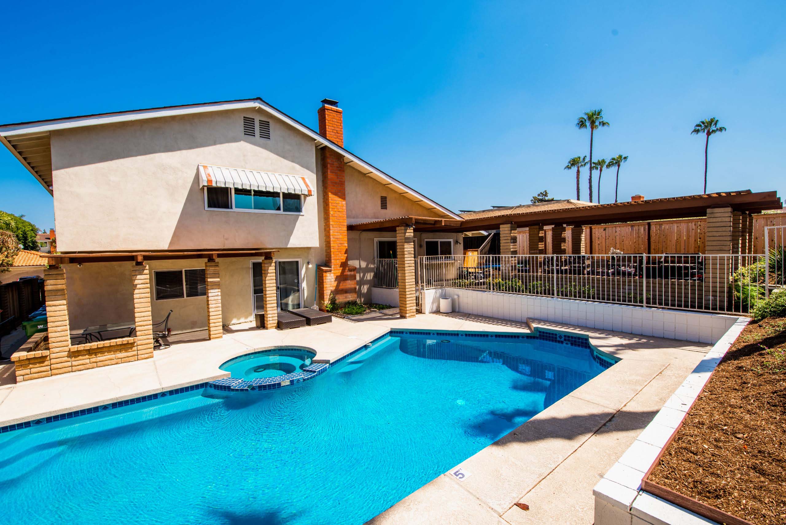 Backyard pool and spa with patio area