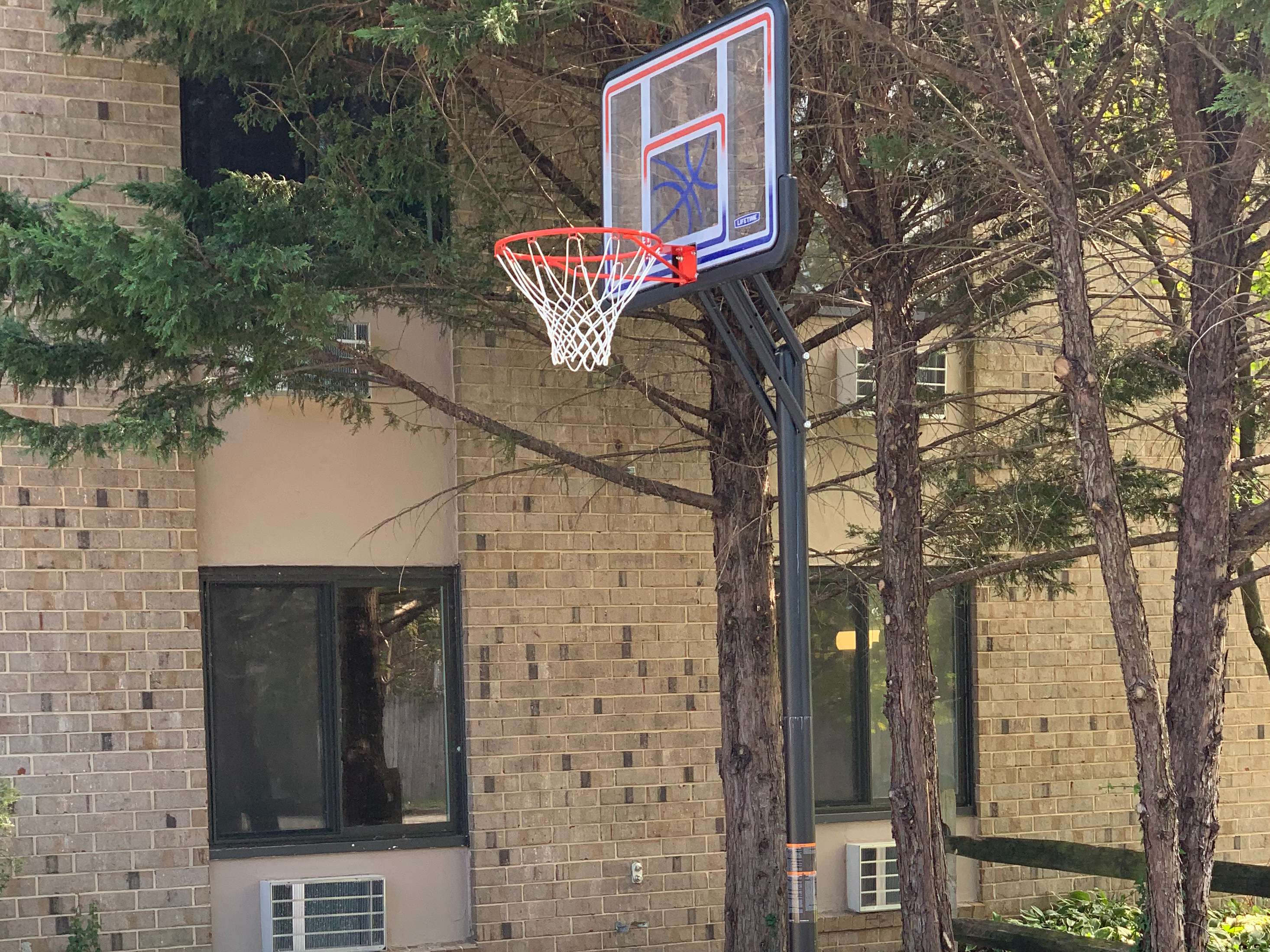 Outdoor basketball hoop near facility building