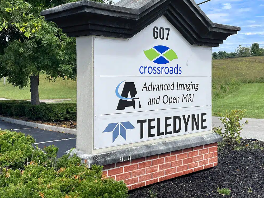 Outdoor sign displaying Crossroads and tenant names