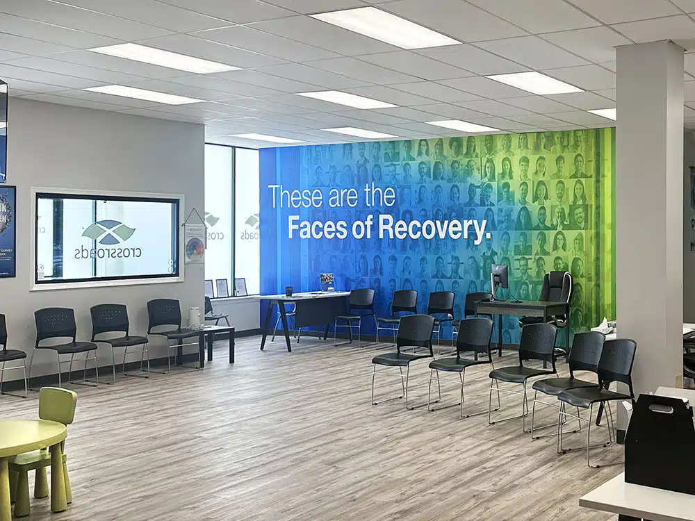 Group seating area with Faces of Recovery wall mural