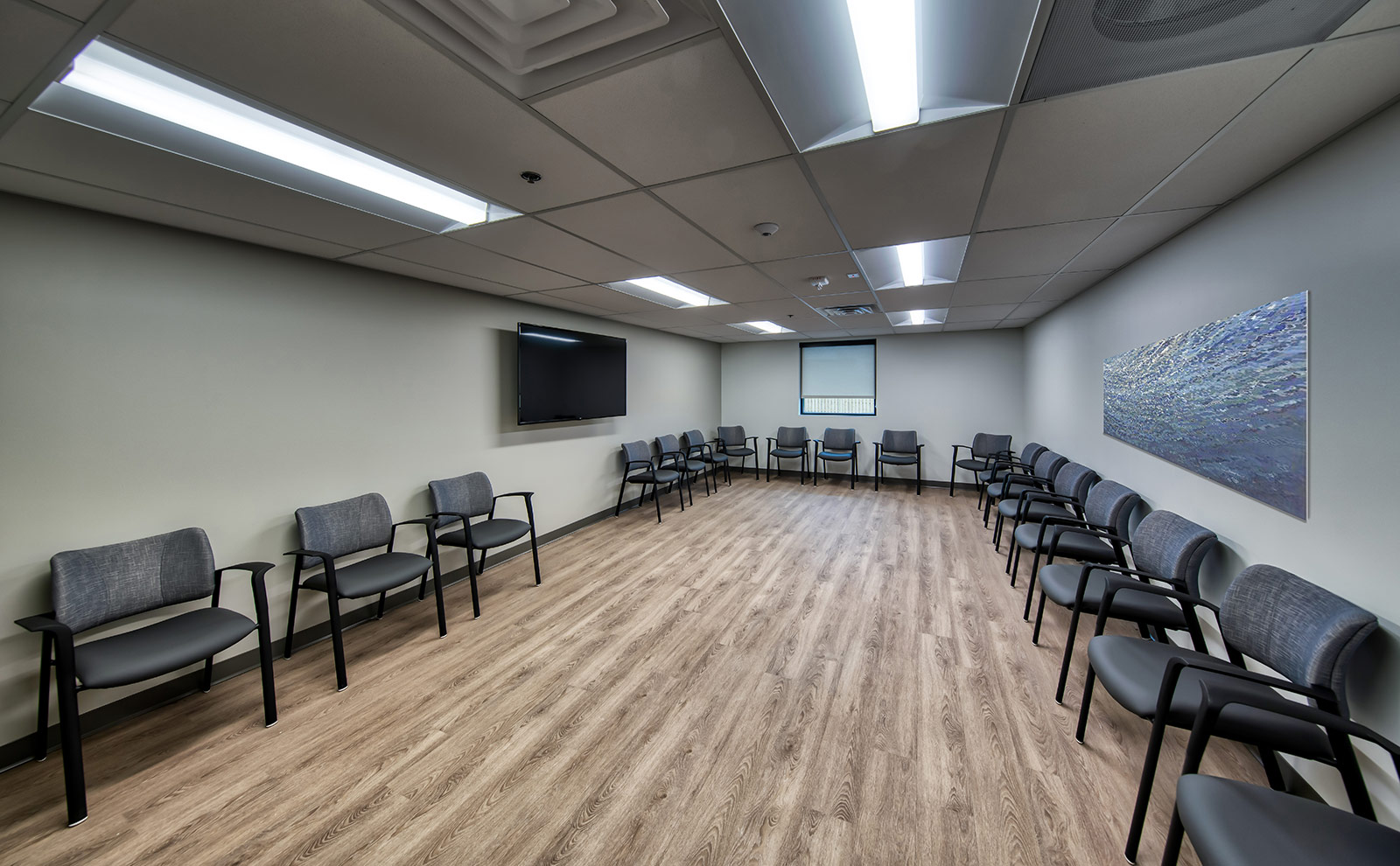 Large circle of chairs with TV and artwork