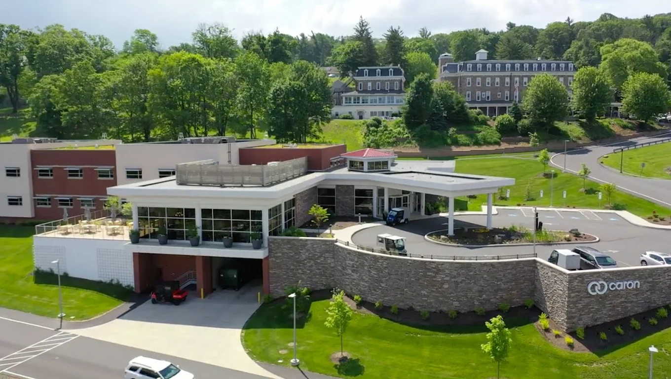 Aerial view of Caron Treatment Centers in Wernersville featuring the modern medical center, landscaped grounds, and surrounding campus buildings