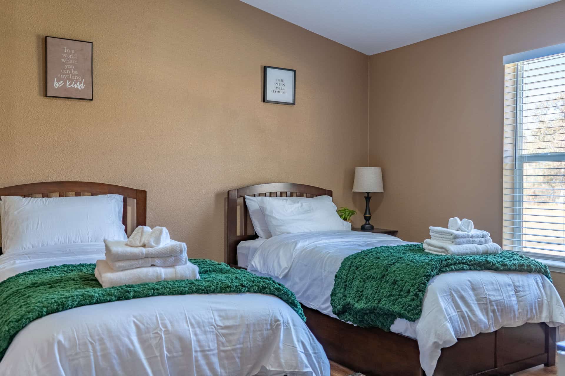 Shared bedroom with two twin beds and folded towels