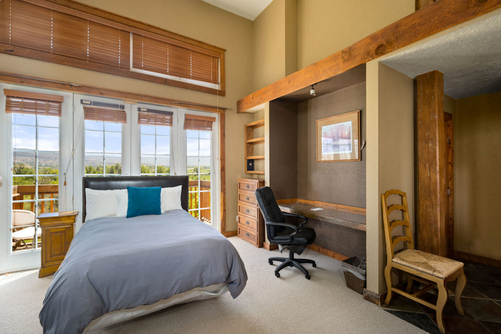 Private bedroom with a bed and desk.