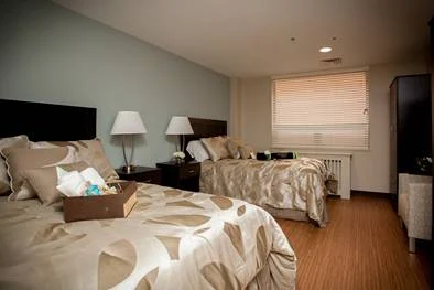 Room with two beds and warm bedding tones