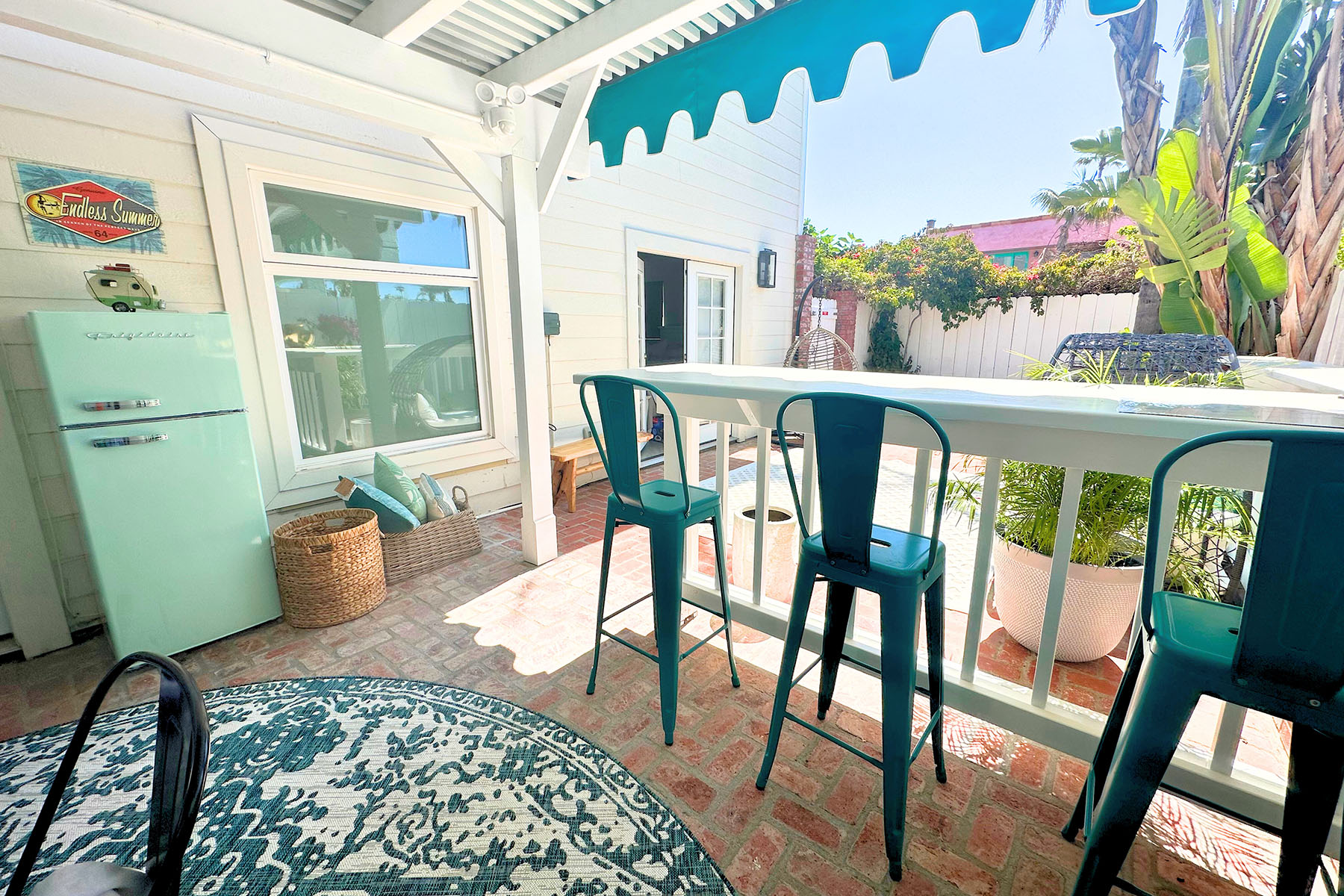 Brick patio with bar stools and retro fridge