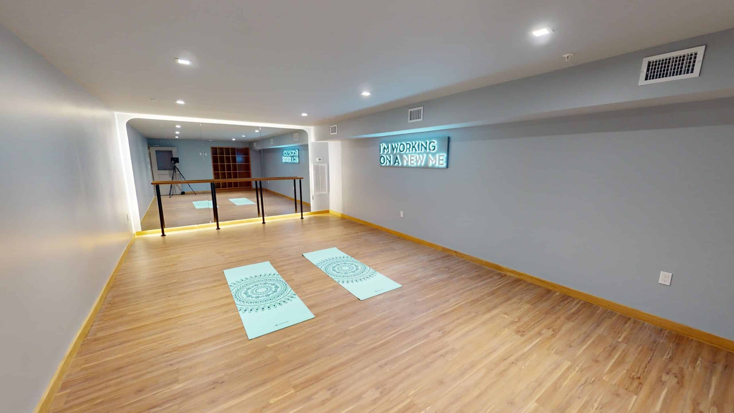 Yoga studio with mats and mirrored wall for wellness sessions